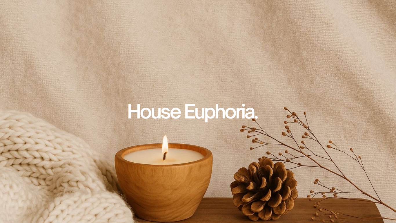 A single lit terracotta candle in a sun-warmed plaster room